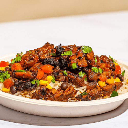 Savory beef stew served over rice with colorful vegetables, cilantro garnish, and rich tomato sauce, perfect for hearty comfort food meals.