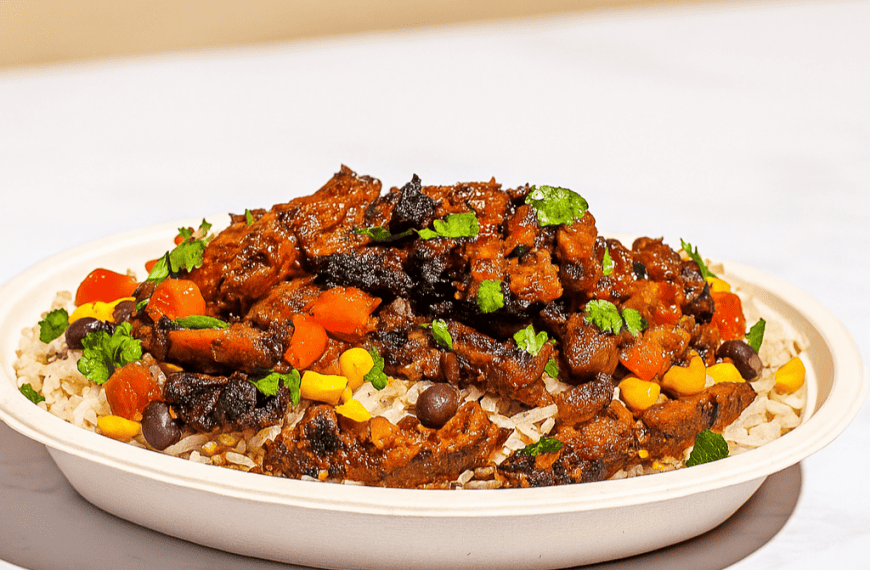 Savory beef stew served over rice with colorful vegetables, cilantro garnish, and rich tomato sauce, perfect for hearty comfort food meals.